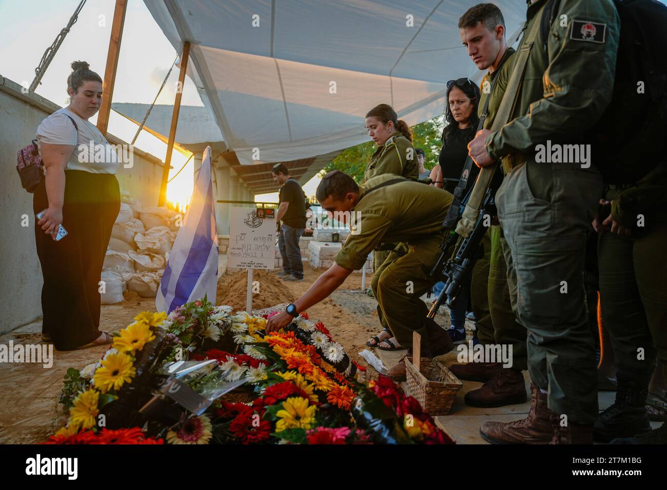 Mourners gather around the grave of Israeli soldier Capt. Shlomo Ben ...