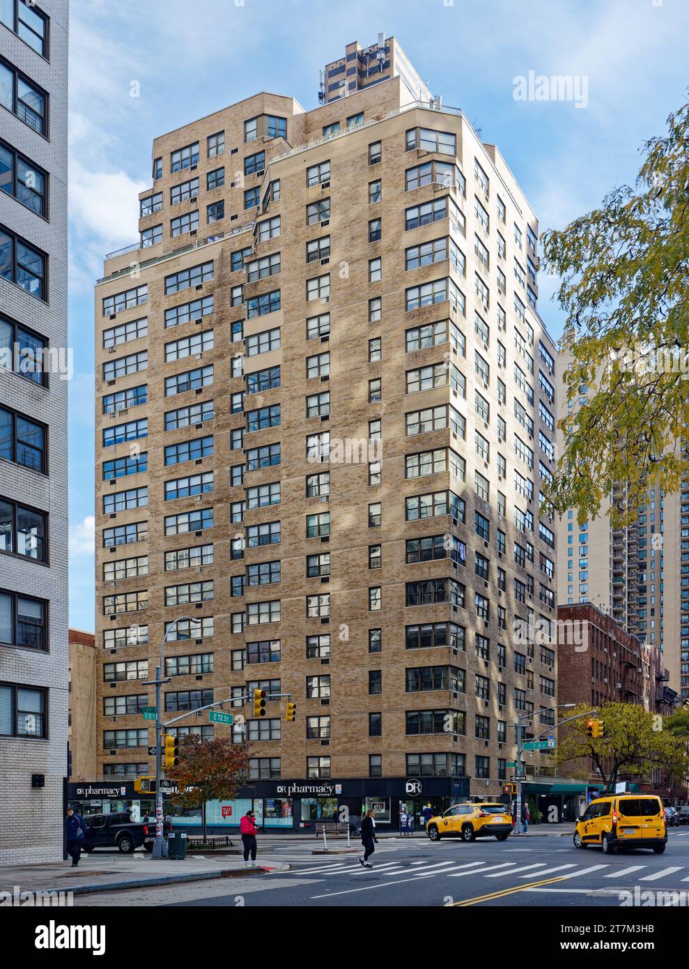 399 East 72nd Street, a brick apartment building with stores designed ...