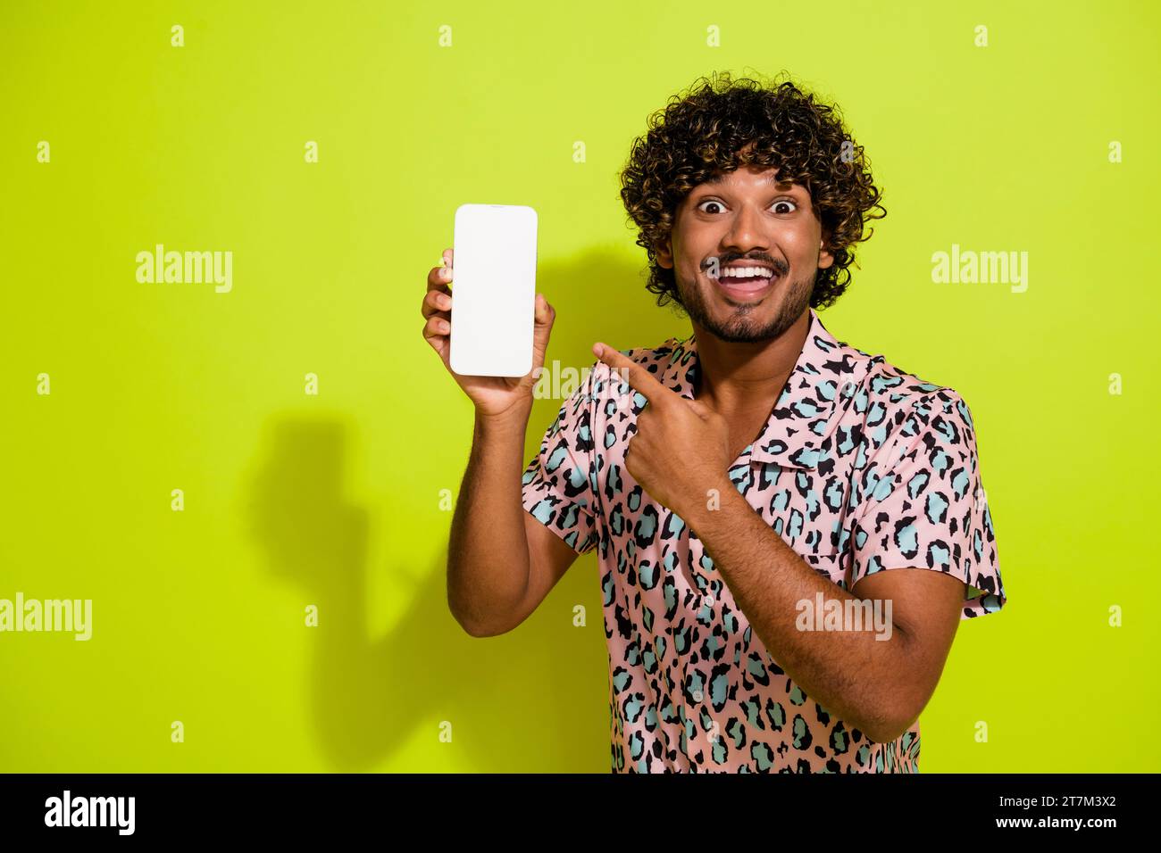 Photo portrait of attractive young man device point screen dressed