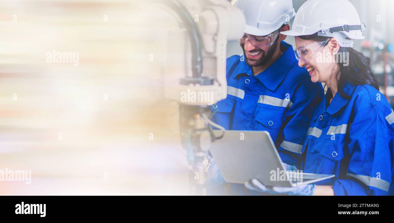 Two engineers mechanic using computer controller Robotic arm for ...