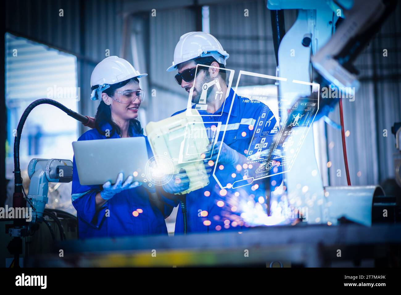 Two engineers mechanic using computer controller Robotic arm for ...