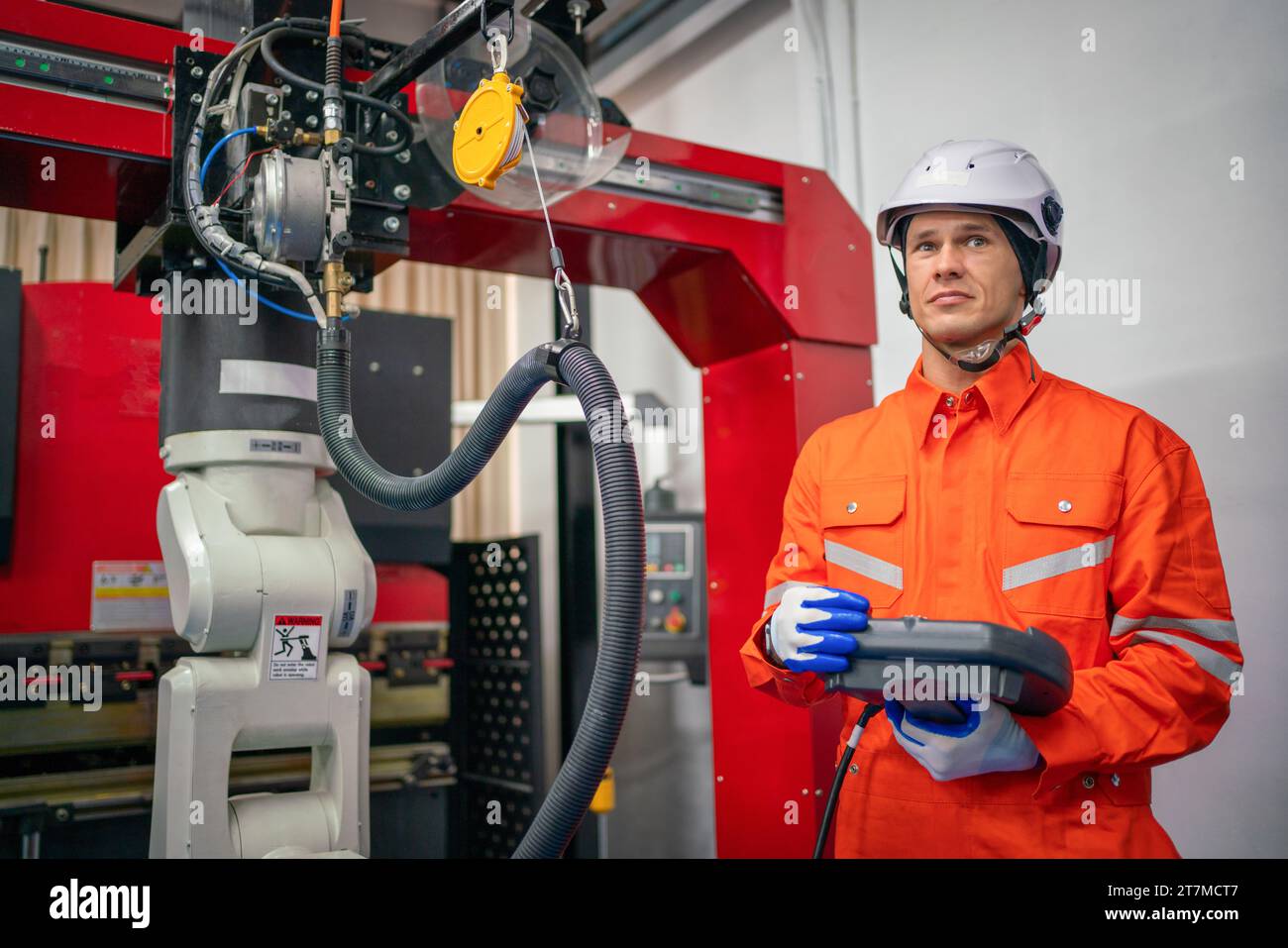 Engineers mechanic using computer controller Robotic arm for welding steel in steel factory