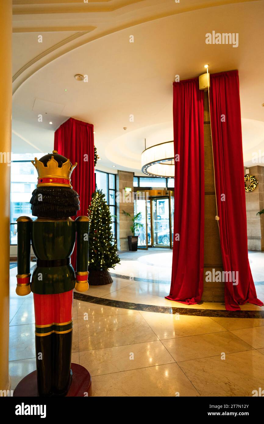 Belfast, Northern Ireland, UK: Lobby of Europa Hotel, the most bombed hotel in the world, with giant nutcracker and red drapes in the circular entranc Stock Photo
