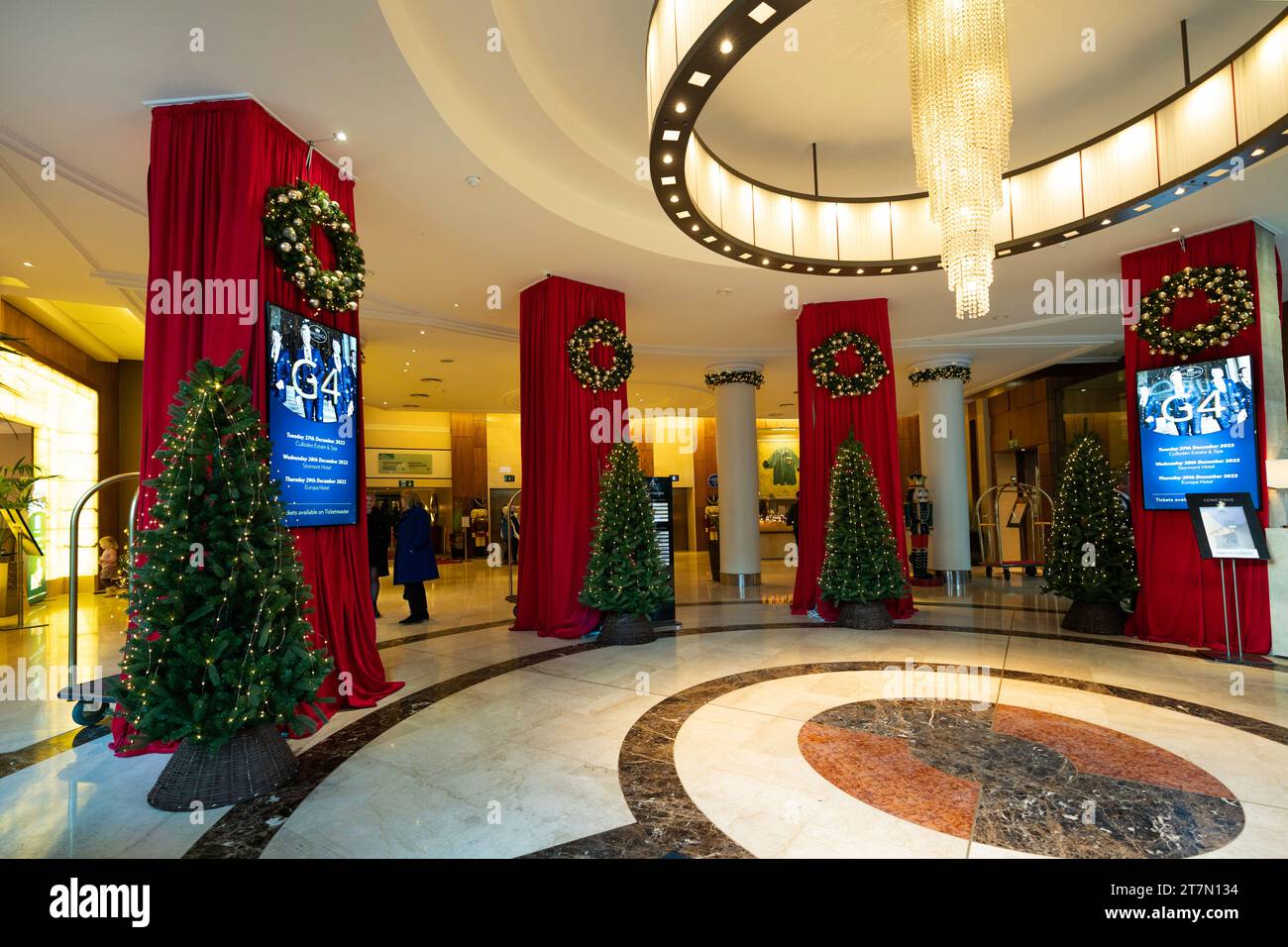 Belfast, Northern Ireland, UK - December 12, 2022: Lobby of Europa Hotel, the most bombed hotel in the world, with giant nutcracker and red drapes in Stock Photo