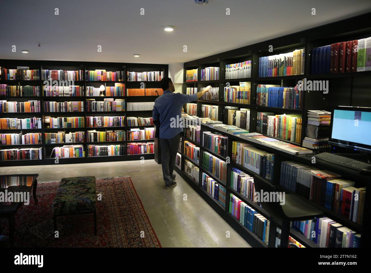 Tehran, Iran. 16th Nov, 2023. A customer browses through titles at a bookstore in northern Tehran. Iran has a rich literary tradition with a long history of producing influential works of literature. Bookstores can be found in major cities, offering a range of titles, including classic Persian literature, contemporary Iranian authors, and translated works. (Credit Image: © Rouzbeh Fouladi/ZUMA Press Wire) EDITORIAL USAGE ONLY! Not for Commercial USAGE! Stock Photo