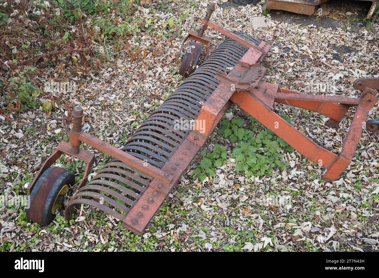 The tiller on this farm is old and rusted Stock Photo Alamy