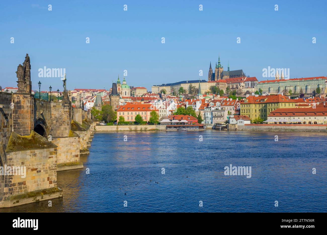 Famous Charles Bridge on Vltava River with Hradcany castle and St. Vitus Cathedral in Prague, Czech Republic, in sunny day Stock Photo