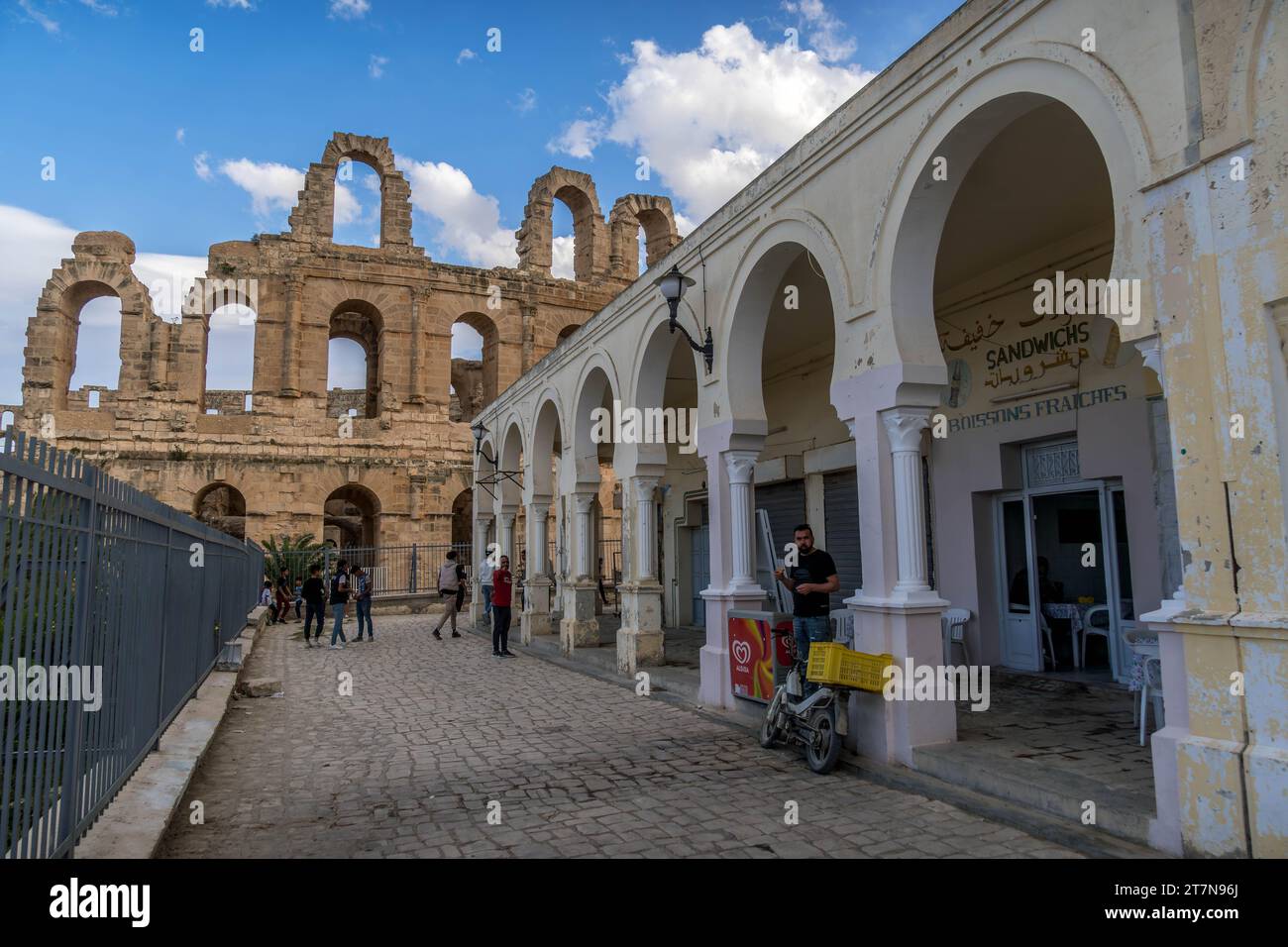 El Jem, Tunisia - November 5, 2023: The streets of Tunisian city El Jem with the old Roman Empire Amphitheatre on the background. Stock Photo