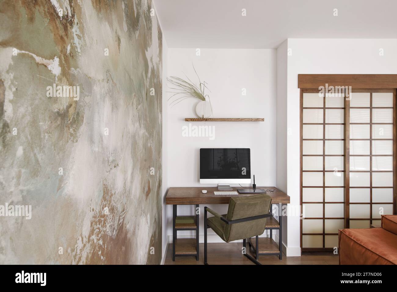 Modern Japandi appartment interior design in earth tones, natural textures with wooden solid oak desk and clay decorative wall. Japandi concept Stock Photo