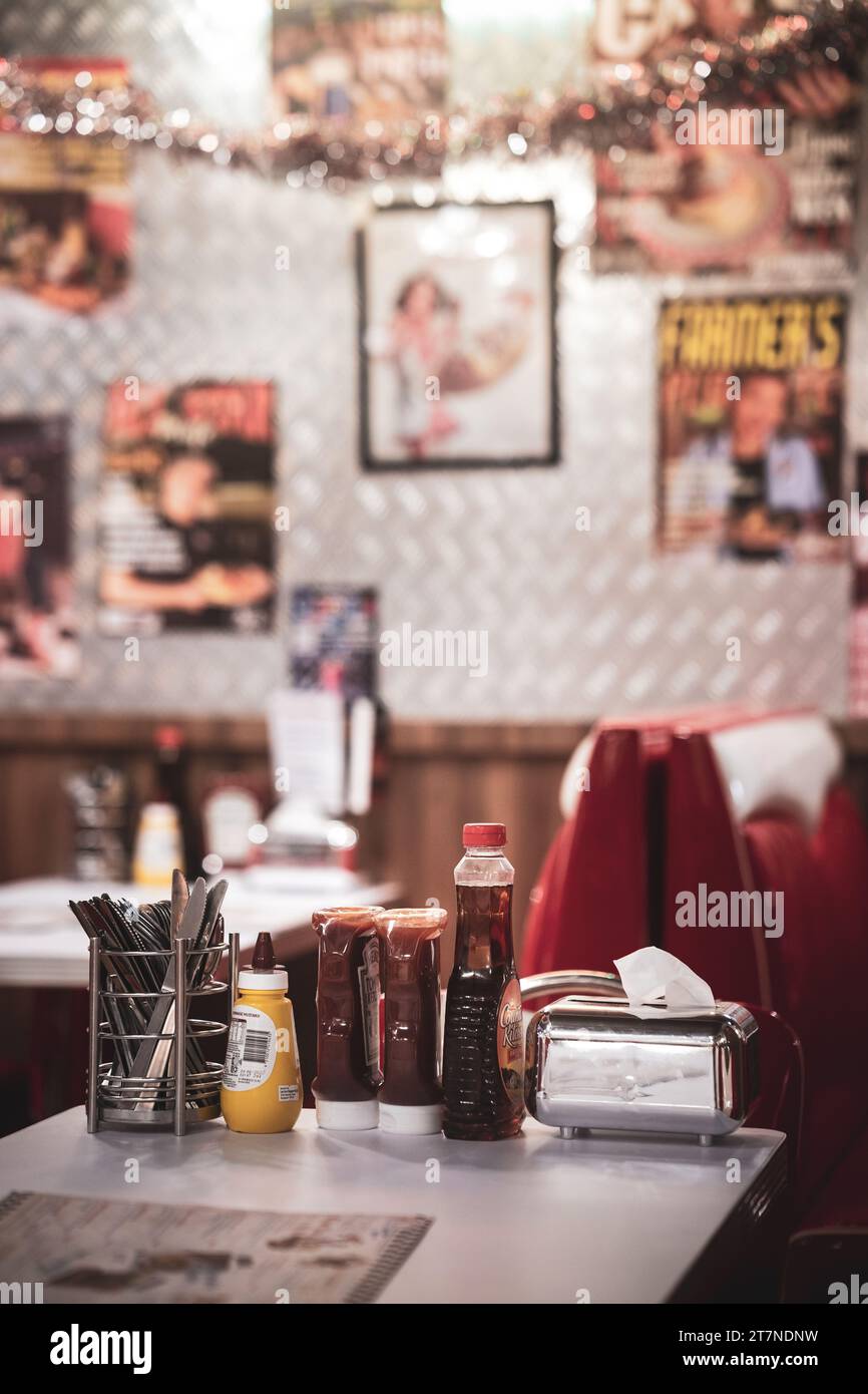 A bar top with a variety of refreshments including assorted flavored juice bottles, condiments, and drink bottles Stock Photo