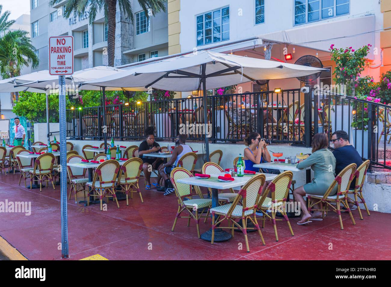 View of people sitting in restaurant, with some tables positioned on