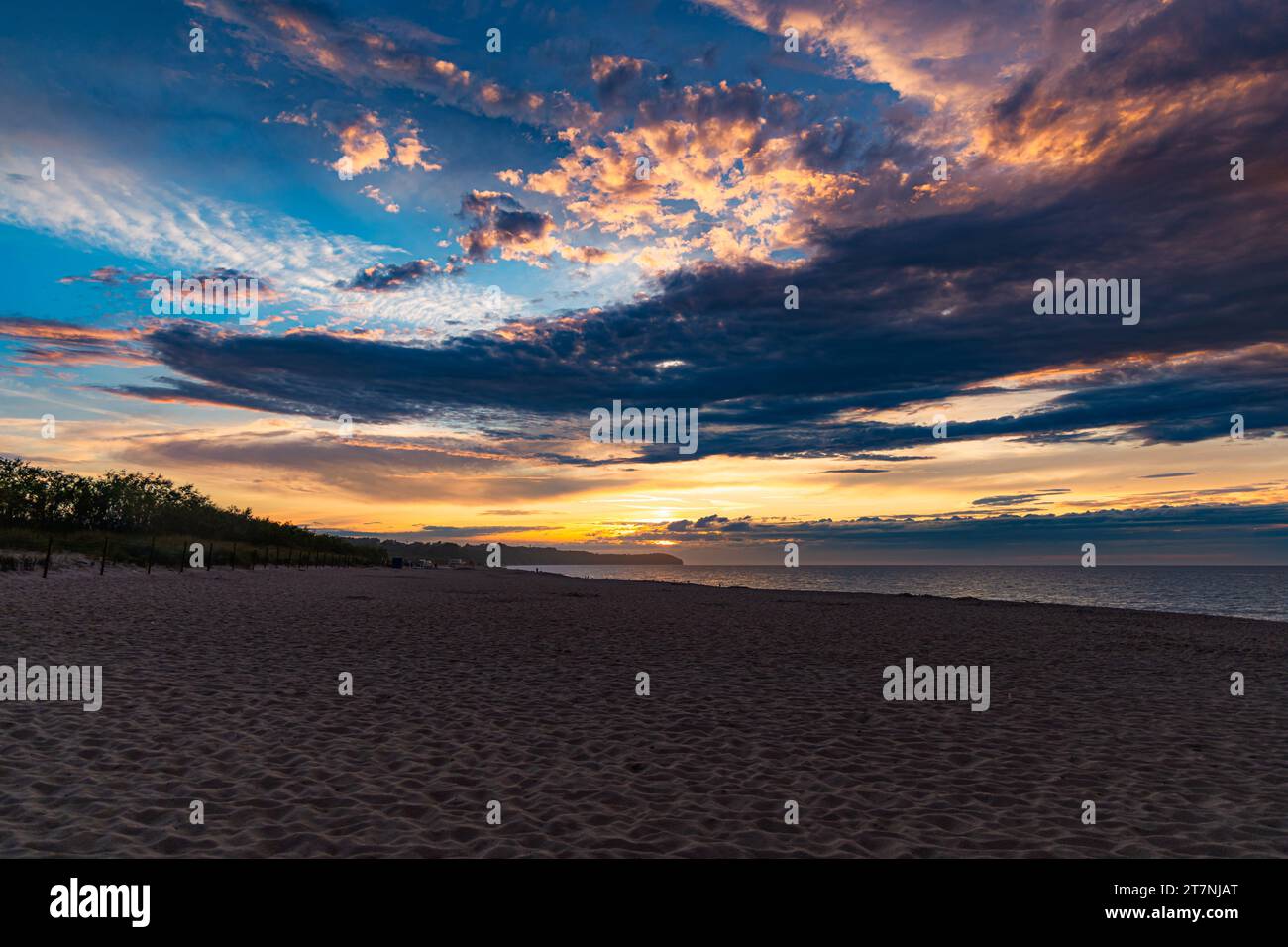 Beautiful dark golden sunset at golden hour at the beach next to dark ...