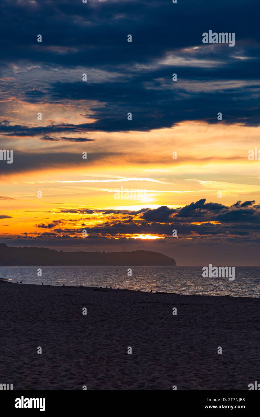 Beautiful dark golden sunset at golden hour at the beach next to dark ...