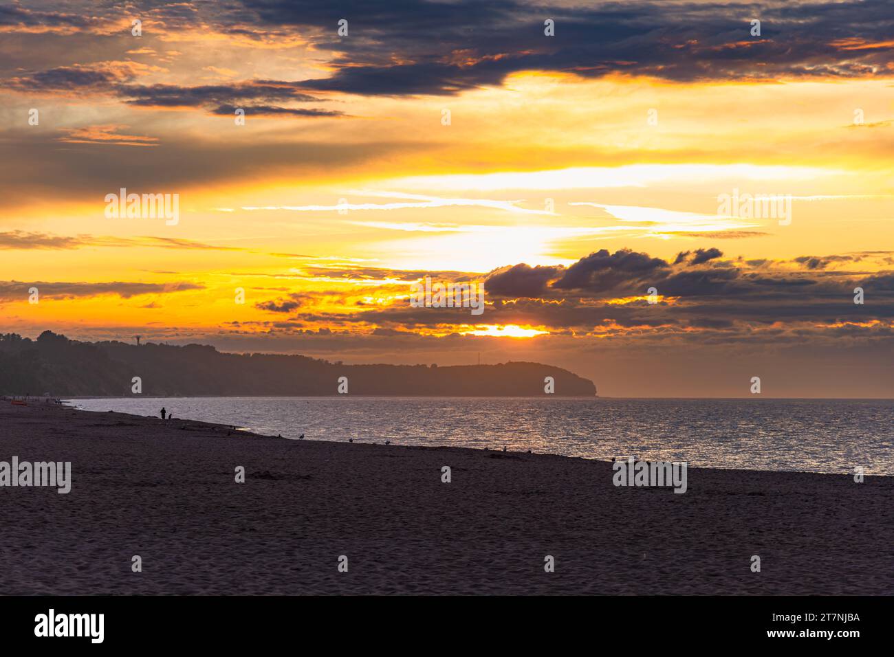 Beautiful dark golden sunset at golden hour at the beach next to dark ...