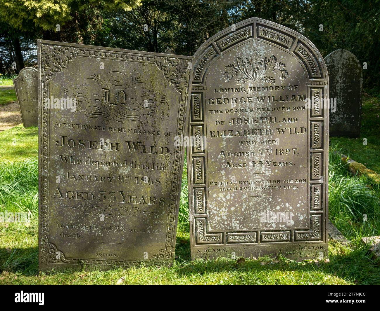 Old slate headstones with ornate carved lettering inscriptions, Little Dalby Church, Leicestershire, England, UK Stock Photo