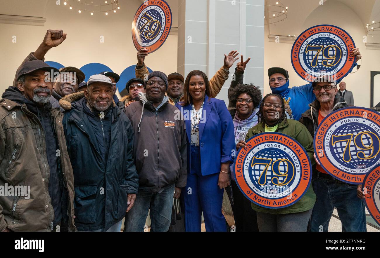 Attorney General Letitia James pose with union members after Governor