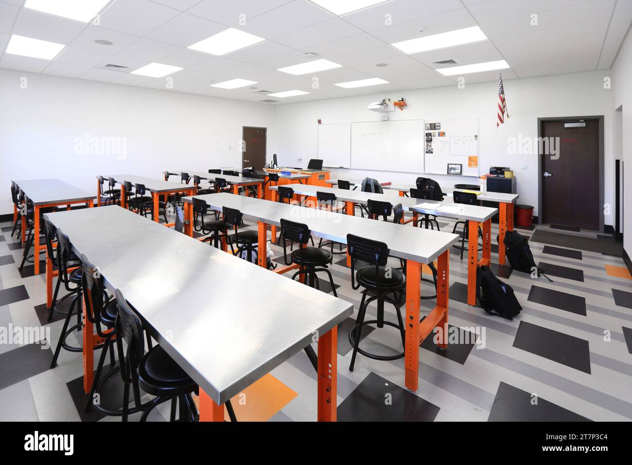 An automotive repair classroom with desks, tables, lab area, and smart projector, in a new modern high school. Stock Photo