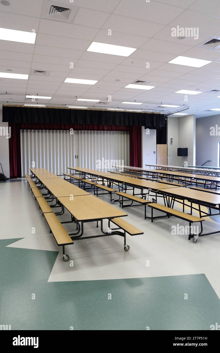 The multipurpose room in a small modern new elementary school, which functions as a gym, lunchroom, meeting room, and theater. Stock Photo