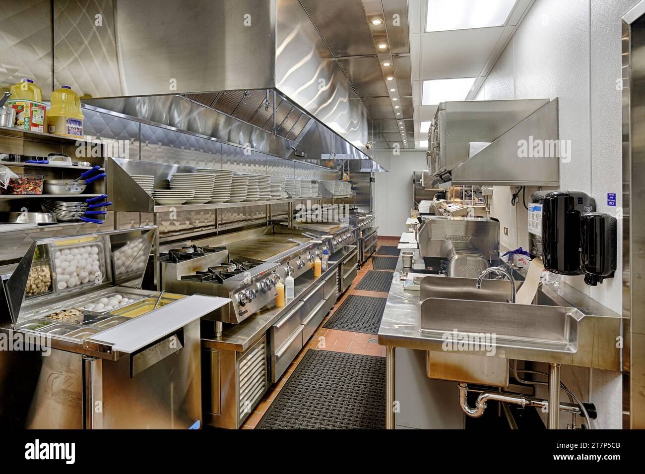 A modern stainless steel diner kitchen, with prep area, grill, griddles