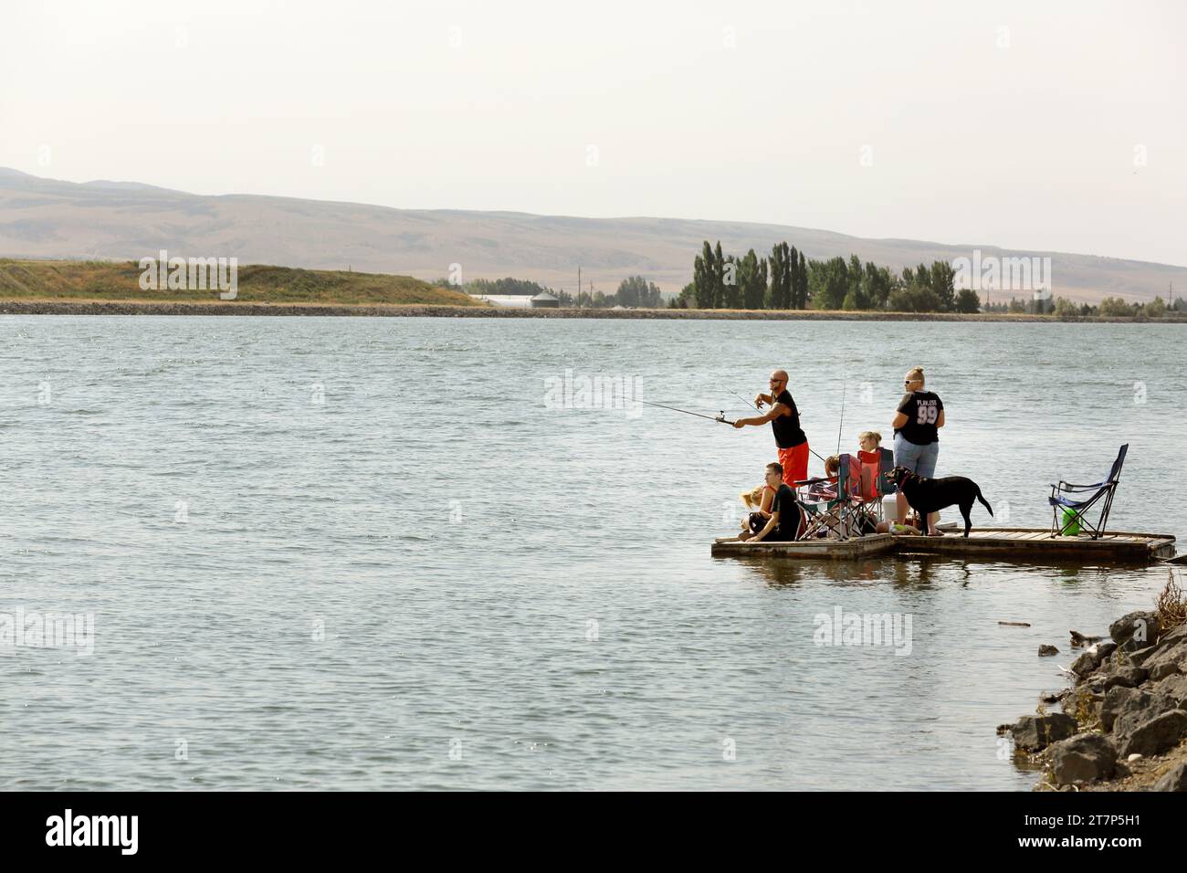 A family fishes from a floating dock on Gem Lake in Idaho Falls, Idaho