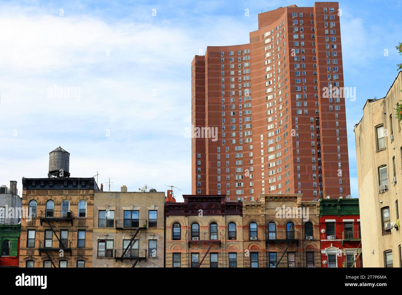 Confucius Plaza 孔子大廈 juxtaposed with tenement buildings in Manhattan Chinatown, New York City Stock Photo