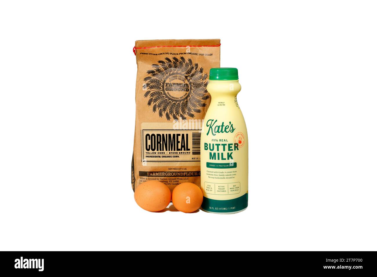 A bag of Farmer Ground Cornmeal, a bottle of Kate's Real Buttermilk, and two eggs isolated on a white background. cutout image for illustration and Stock Photo
