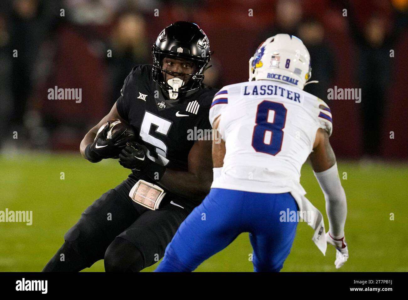 Iowa State running back Cartevious Norton (5) runs from Kansas cornerback Kwinton Lassiter (8