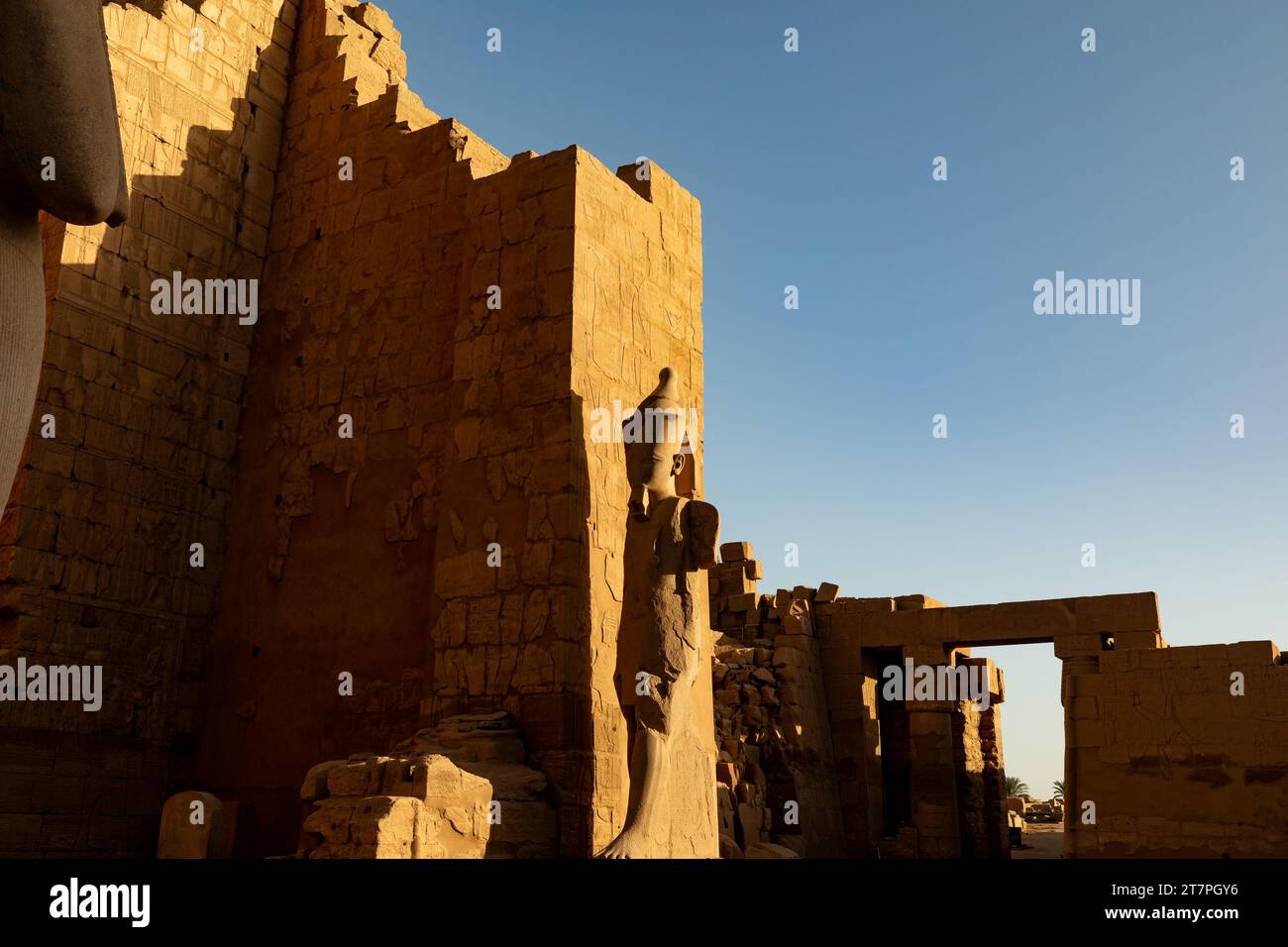 Large stone pharo statue in the ancient ruins of Karnak Temple complex ...