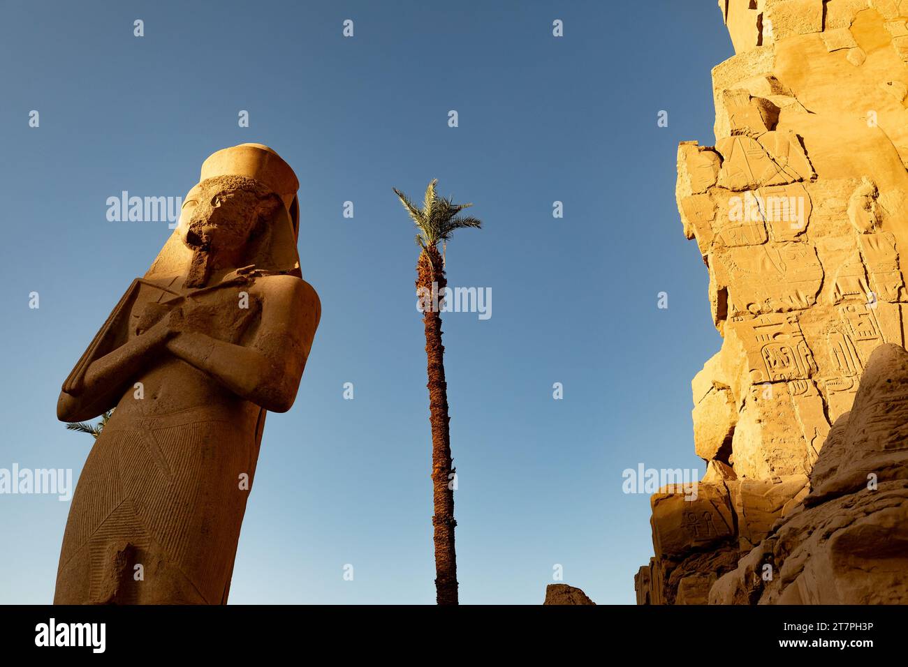 Large stone pharo statue in the ancient ruins of Karnak Temple complex ...