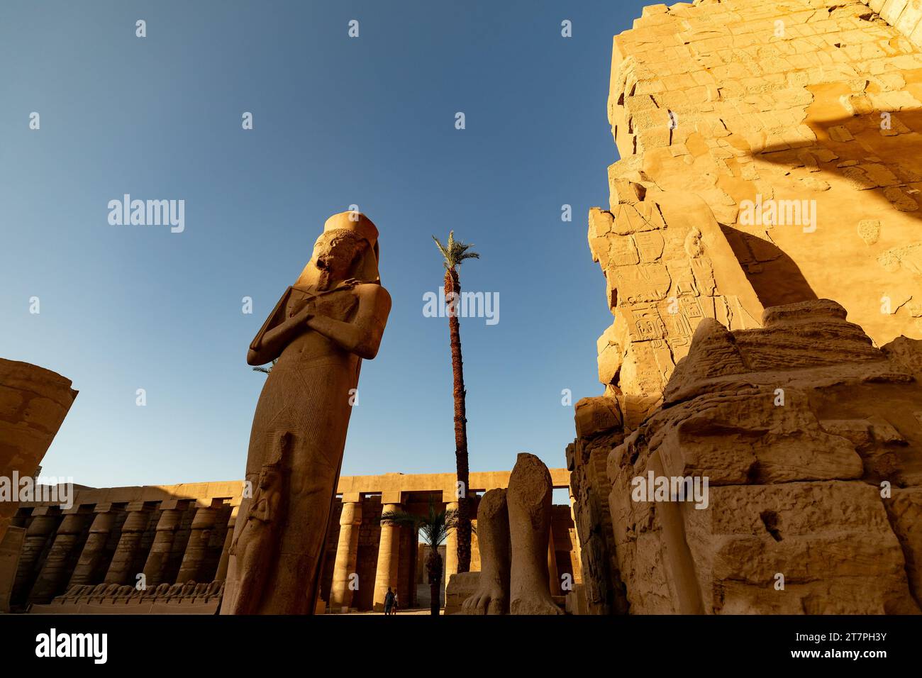 Large stone pharo statue in the ancient ruins of Karnak Temple complex ...