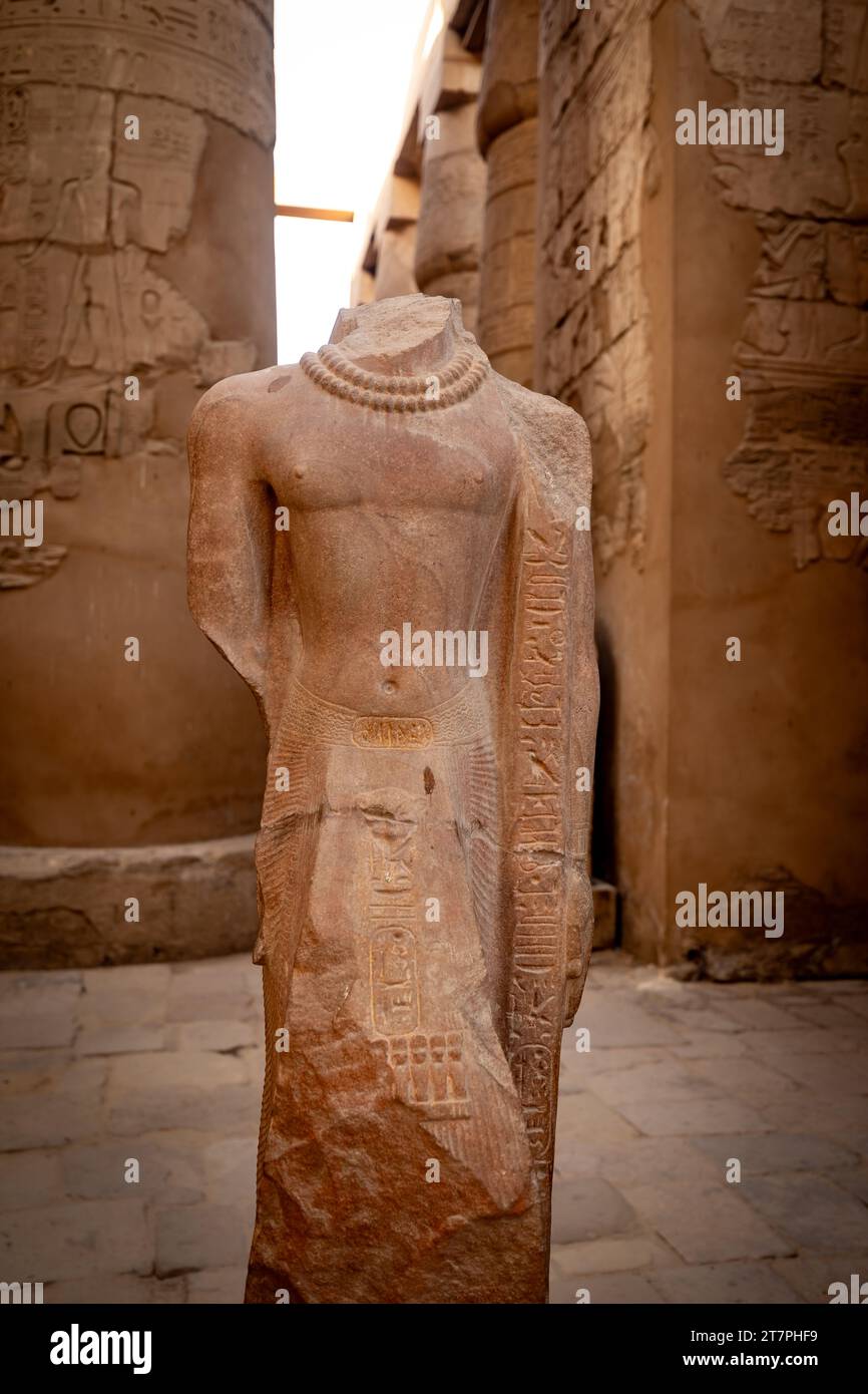 Large stone pharo statue in the ancient ruins of Karnak Temple complex in the Egyptian Desert city of Luxor Stock Photo