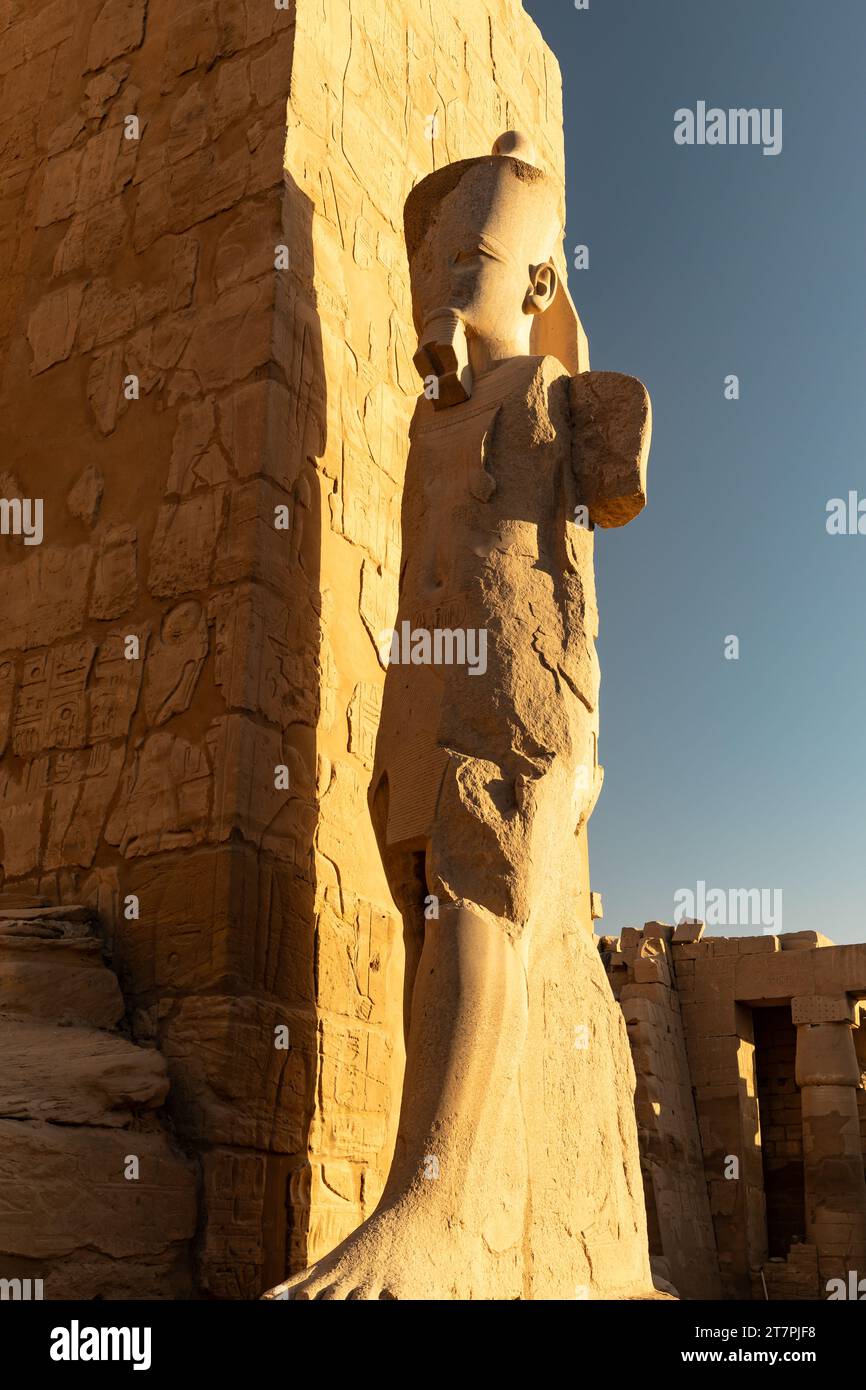 Large stone pharo statue in the ancient ruins of Karnak Temple complex ...