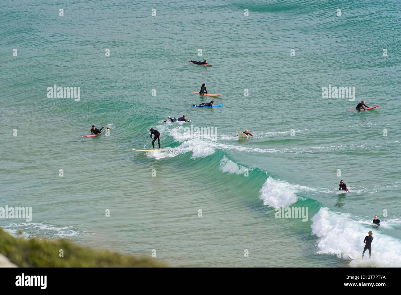 Surfers in the surf at Sagres beach, Faro district, Algarve, Portugal Stock Photo
