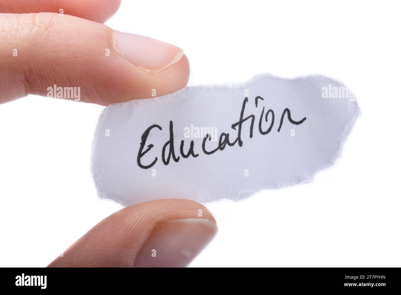 Child hand holding a education written a piece of torn paper Stock Photo