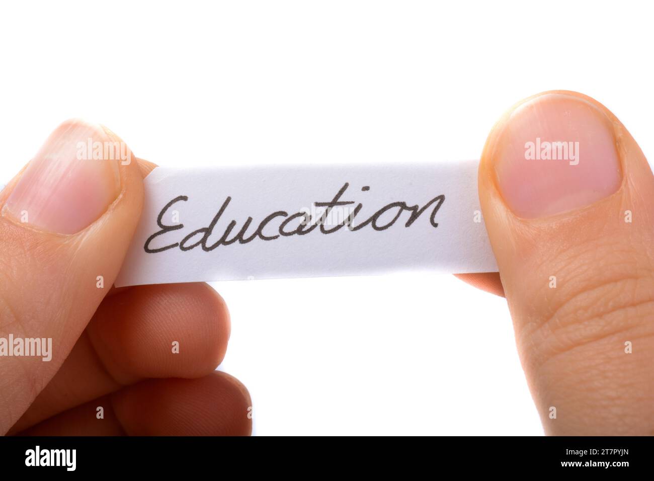 Child hand holding a education written a piece of torn paper Stock Photo