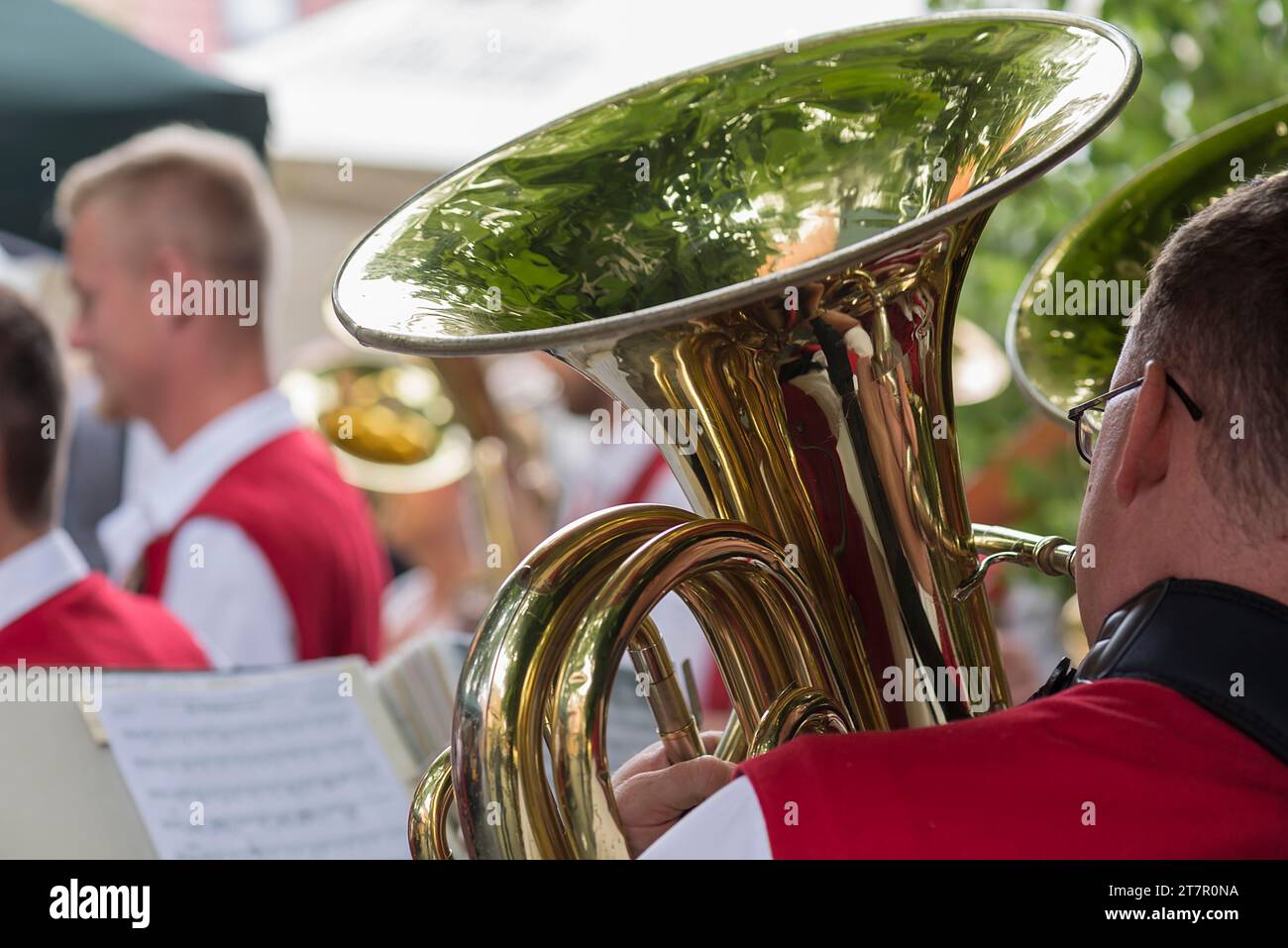 Musician with tuba and sheet of music plays for dancing Tanzlindenfest