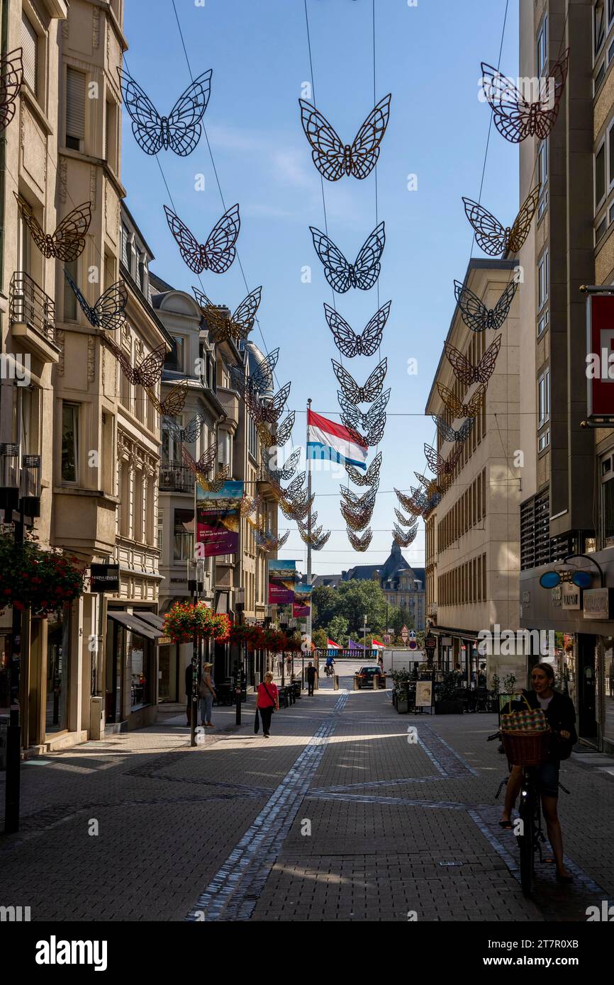 Rue Philippe II with decorative butterflies in the air and the