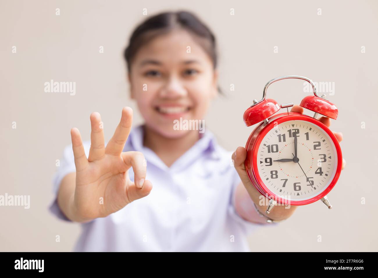 Teen girl student with alarm time clock for ready education times back to school concept happy smile. Stock Photo