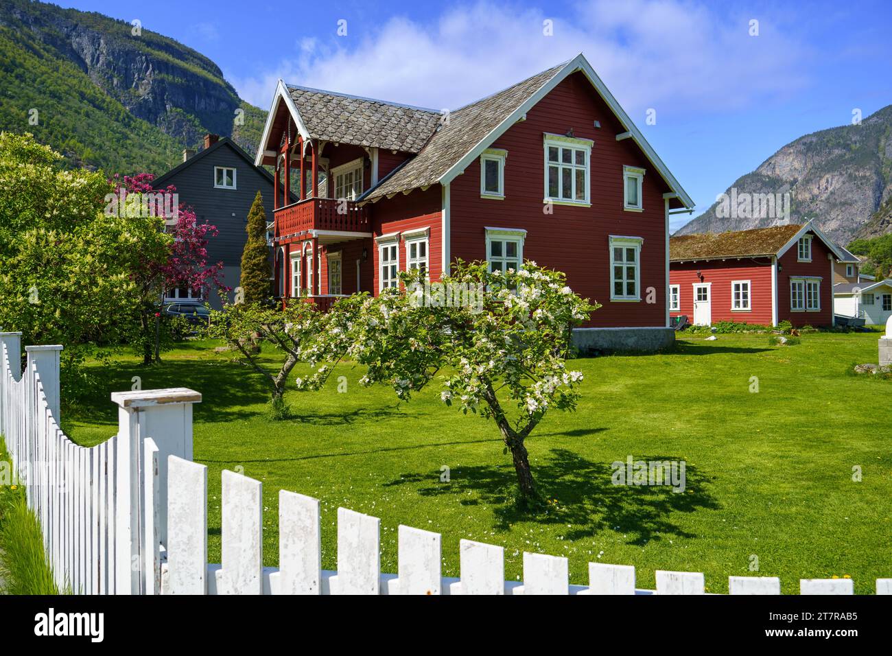 Red Norwegian house and its pretty garden Stock Photo