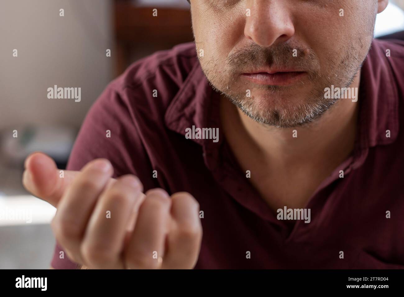 man chews a piece of homemade cucumber with his mouth closed Stock Photo