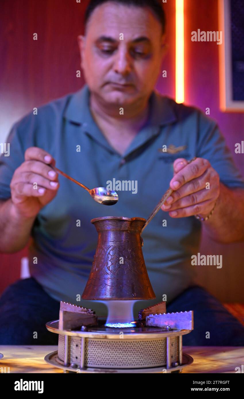 Haikou, China's Hainan Province. 2nd Nov, 2023. Mehmet Arif Firat makes coffee at his restaurant Romantic Turkey in Haikou, south China's Hainan Province, Nov. 2, 2023. TO GO WITH 'Across China: Restaurant owner brings tastes of T¨¹rkiye to tropical island of Hainan' Credit: Guo Cheng/Xinhua/Alamy Live News Stock Photo