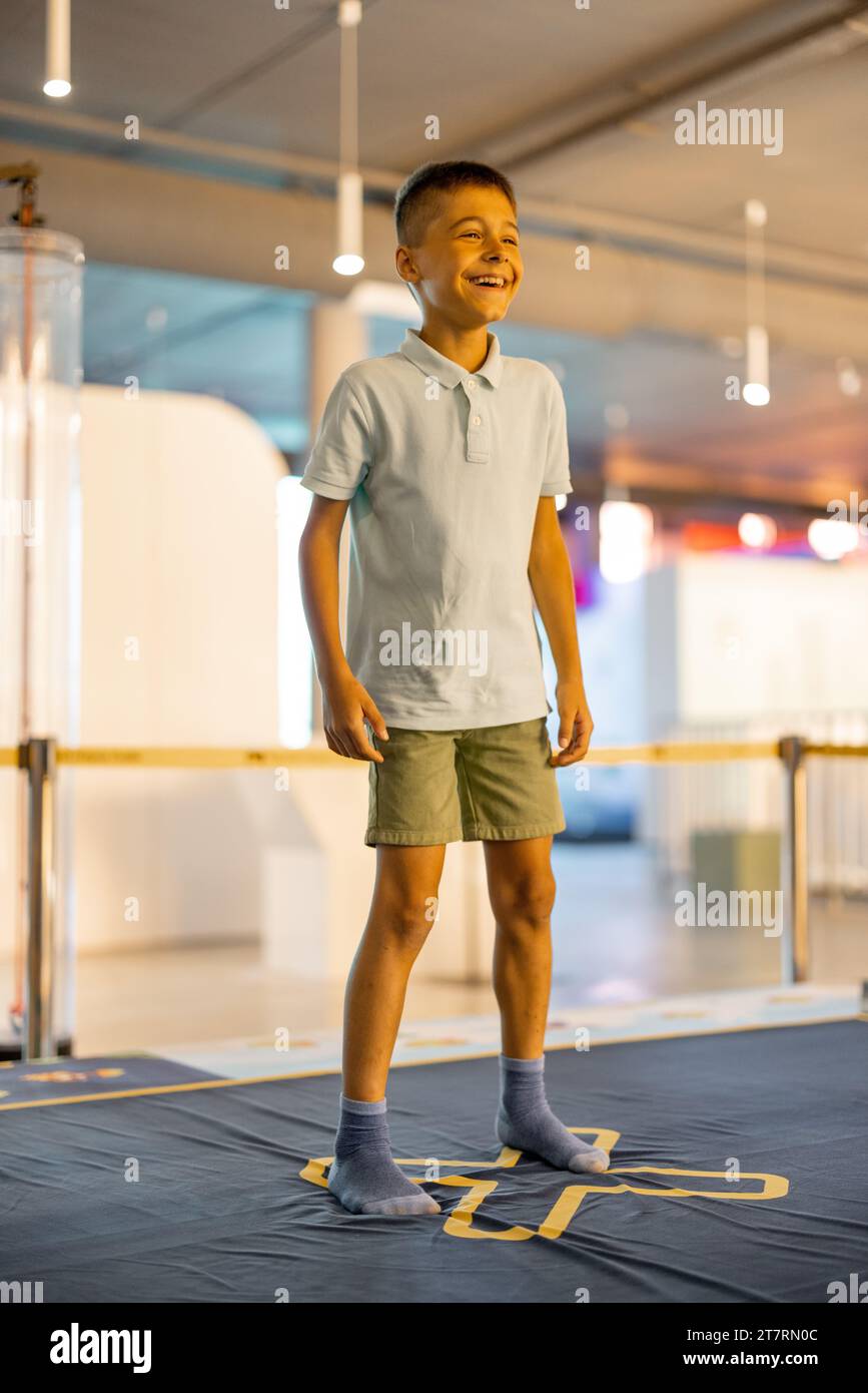 Little boy jumps on a playground in science museum Stock Photo - Alamy