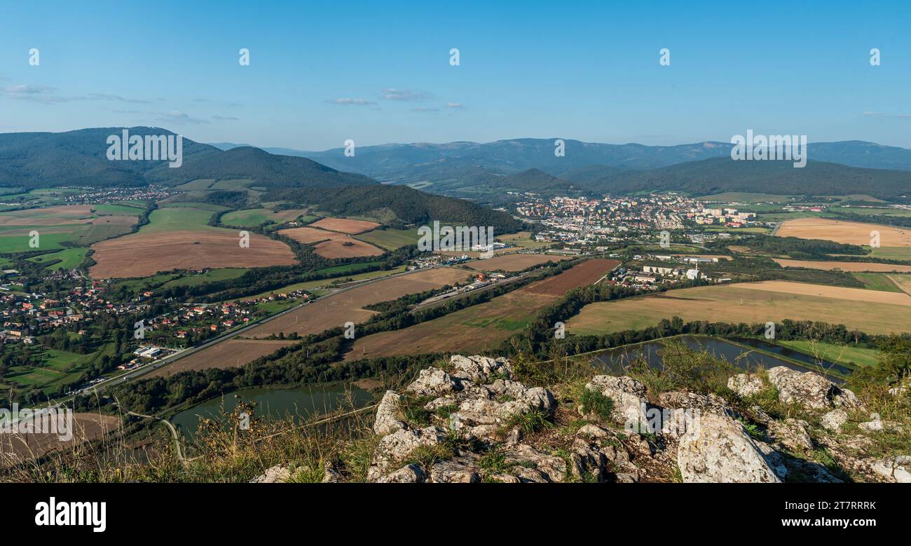 Roznava city with hills of Slovenske rudohorie mountains from Brzotinske skaly viewpoint in Slovensky kras national park in Slovakia Stock Photo