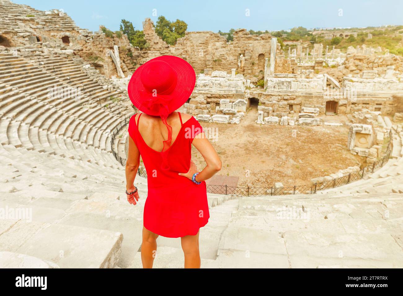 Tourist woman of top of Roman theatre in Side archaeological site in Turkey. The city's blend of Hellenistic, Roman, and Byzantine influences is Stock Photo