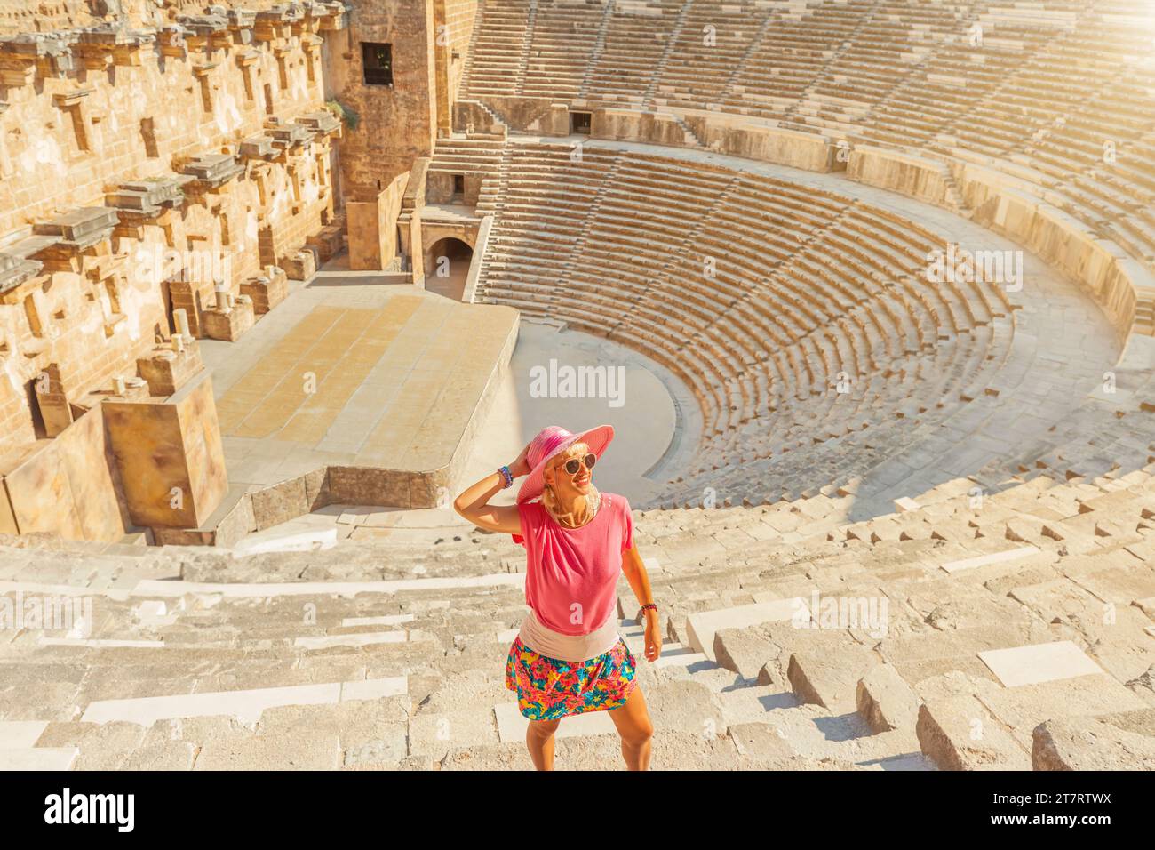 tourist girl visiting Roman Theatre Aspendos in Turkey has seating arrangement for 7000 spectators, exceptional acoustics, even a whisper from stage Stock Photo