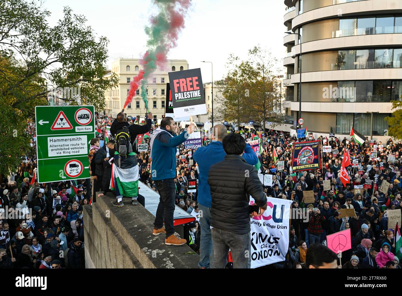 Protestors stand on walls and march through London in support of