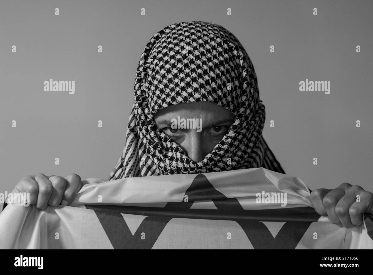 Green-eyed woman with Palestinian headscarf carrying an Israeli flag. Conflict concept Stock Photo