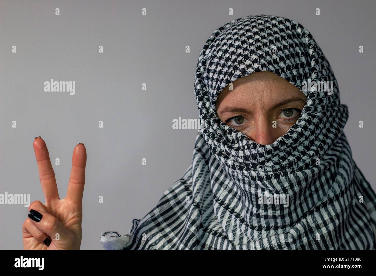 Greeneyed woman wearing a Palestinian scarf. Conflict concept Stock
