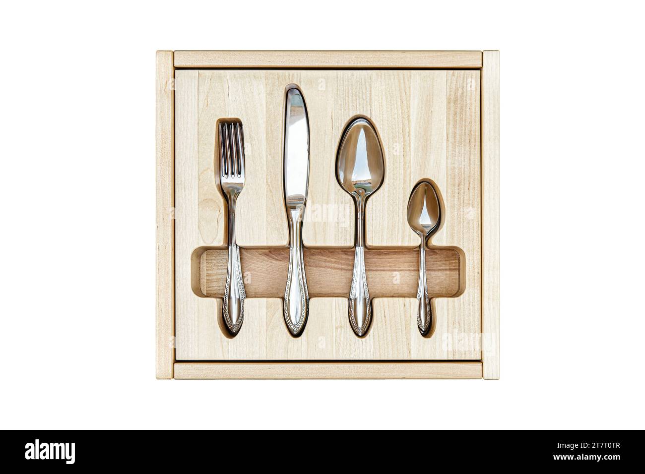 Shiny silverware in craved wooden tray in serving table drawer isolated