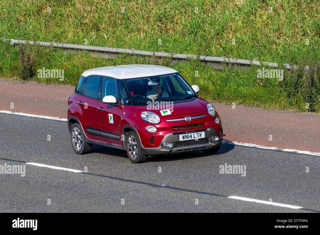 2014 Fiat 500L Trekking Multijet 105 Start/Stop Red Car Hatchback Diesel 1598 cc with Green P provisional L plates driving on the M6 motorway, UK Stock Photo